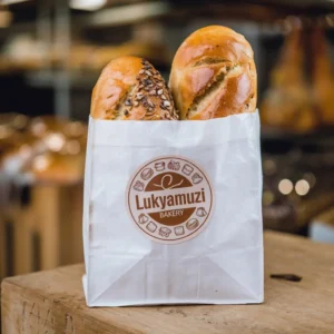 Bakery paper bags branded with Lukyamuzi Bakery logo, designed for fresh bread packaging with eco-friendly materials ideal for retail bakery presentation.